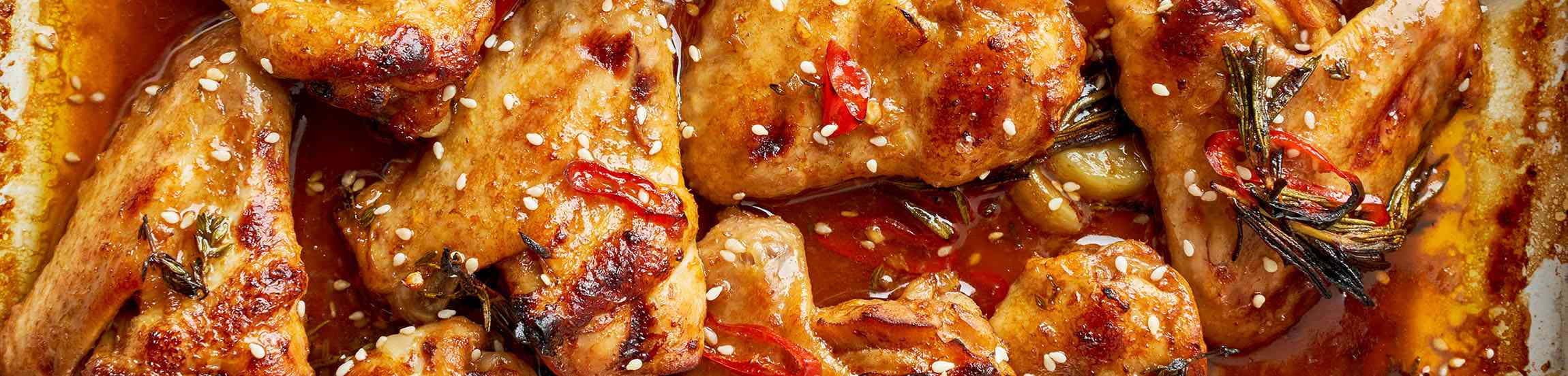 Barbecue chicken wings. Sticky asian spicy wings with teriyaki. Long width banner. Oven baked